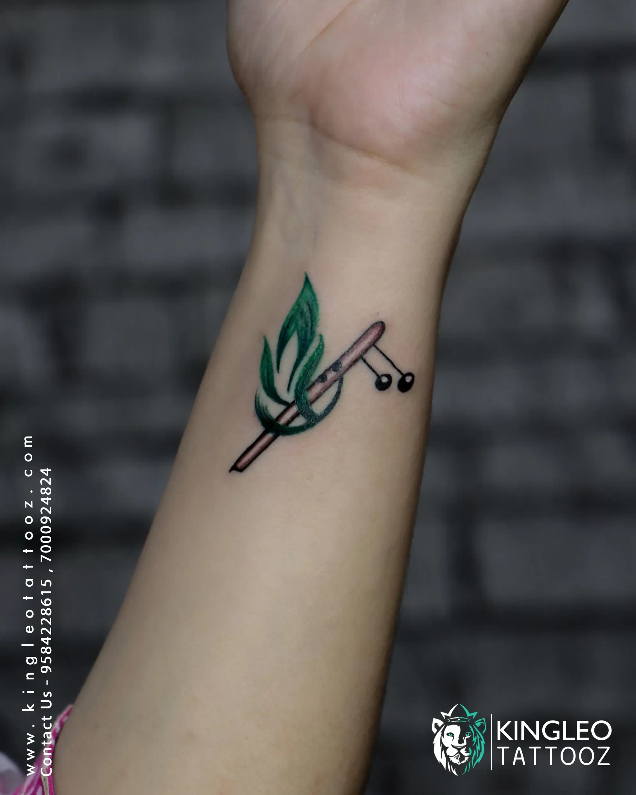 Karan Tattooz - This concept is of Shri Krishna's flute and peacock  feathers.The client asked me for religious tattoos And I suggest this  concept to make attractive , simple & gorgeous looking
